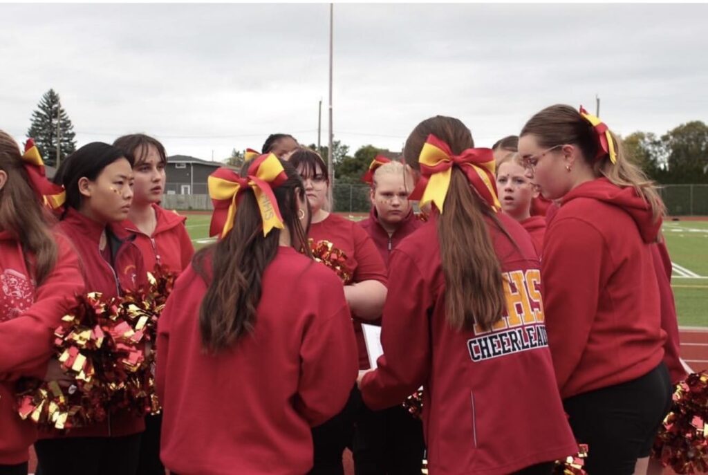 hammarskjold-cheerleading-teammates-on-field