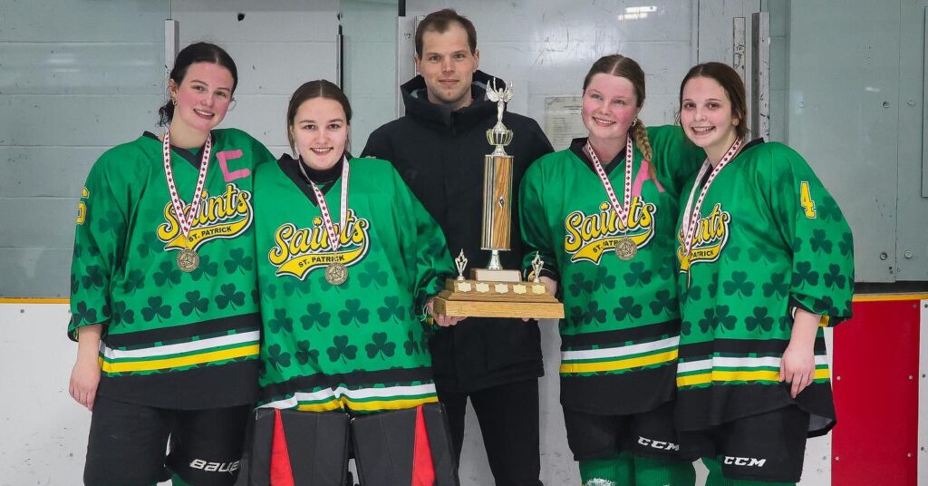 st-patrick-girls-hockey-team-players-with-coach-and-trophy