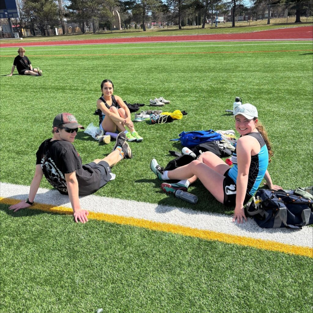 superior-track-&-field-group-sitting-on-field