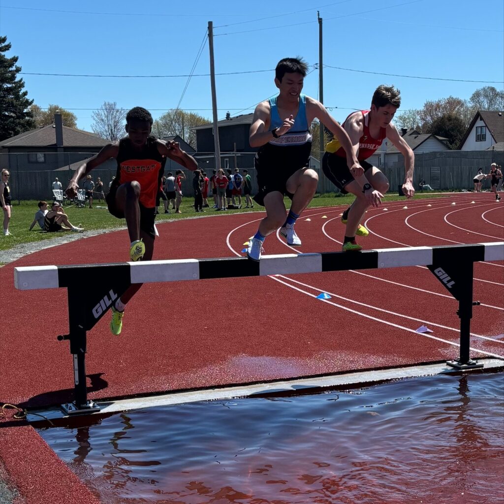 superior-track-&-field-boys-running-jumping-in-water