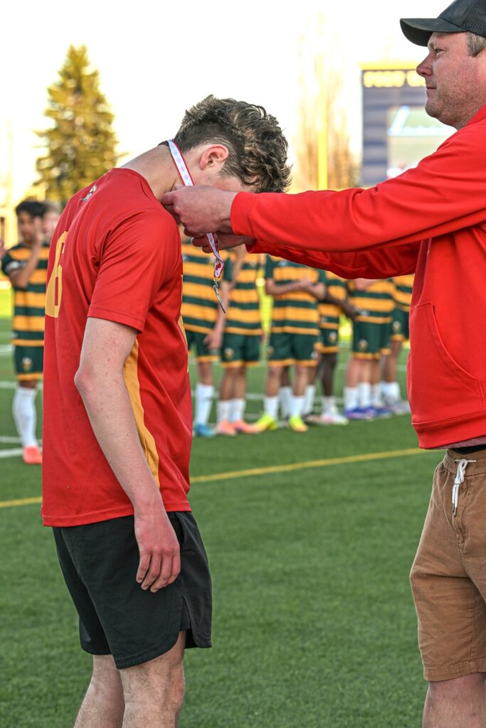 hammarskjold-boys-soccer-team-receiving-metal