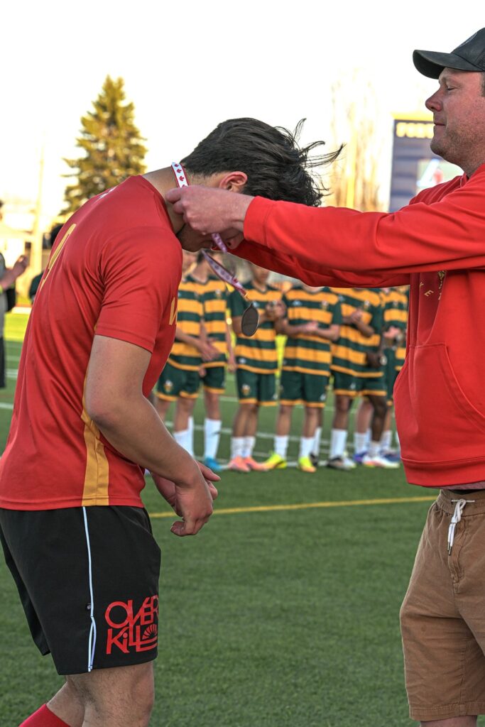 hammarskjold-boys-soccer-team-receiving-metal