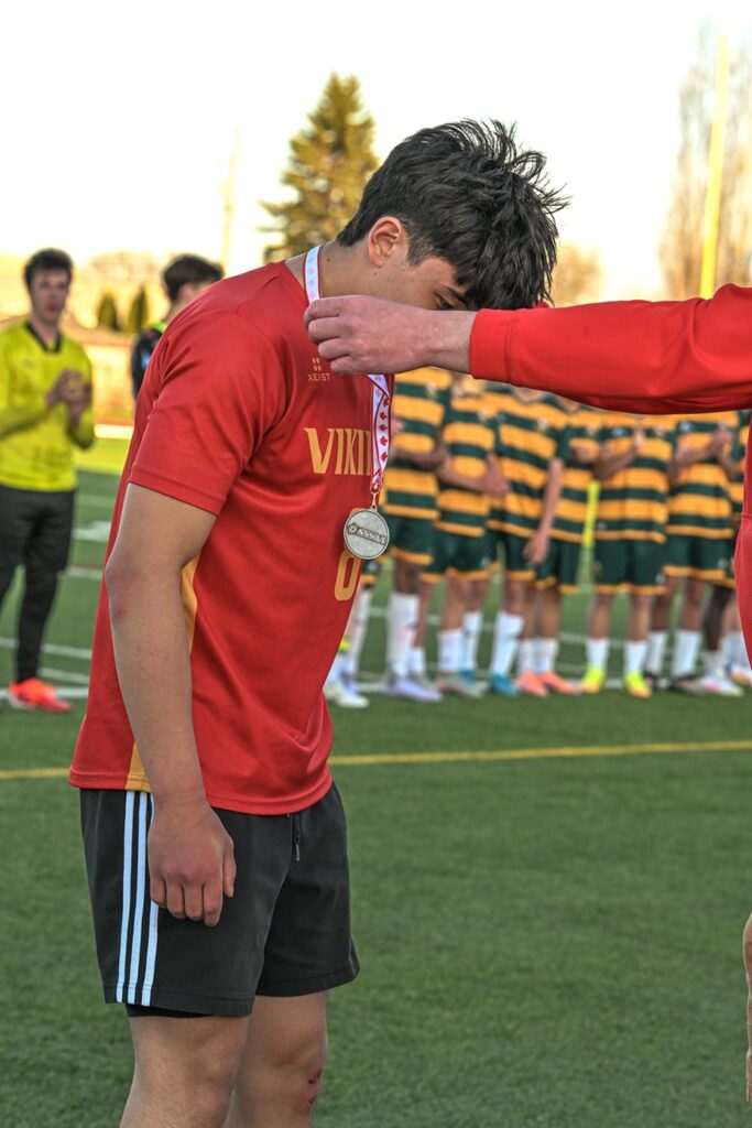hammarskjold-boys-soccer-team-receiving-metal